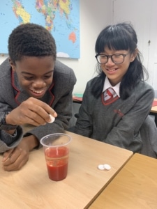 Heritage Year 9 Geography pupils carrying out a classroom volcano eruption experiment.