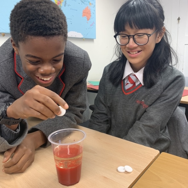 Heritage Year 9 Geography pupils carrying out a classroom volcano eruption experiment.