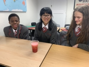 Heritage Year 9 Geography pupils carrying out a classroom volcano eruption experiment.